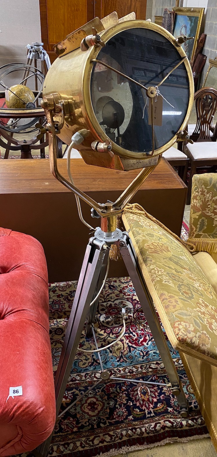 A vintage style brass spotlight floor lamp on tripod stand, height 152cm